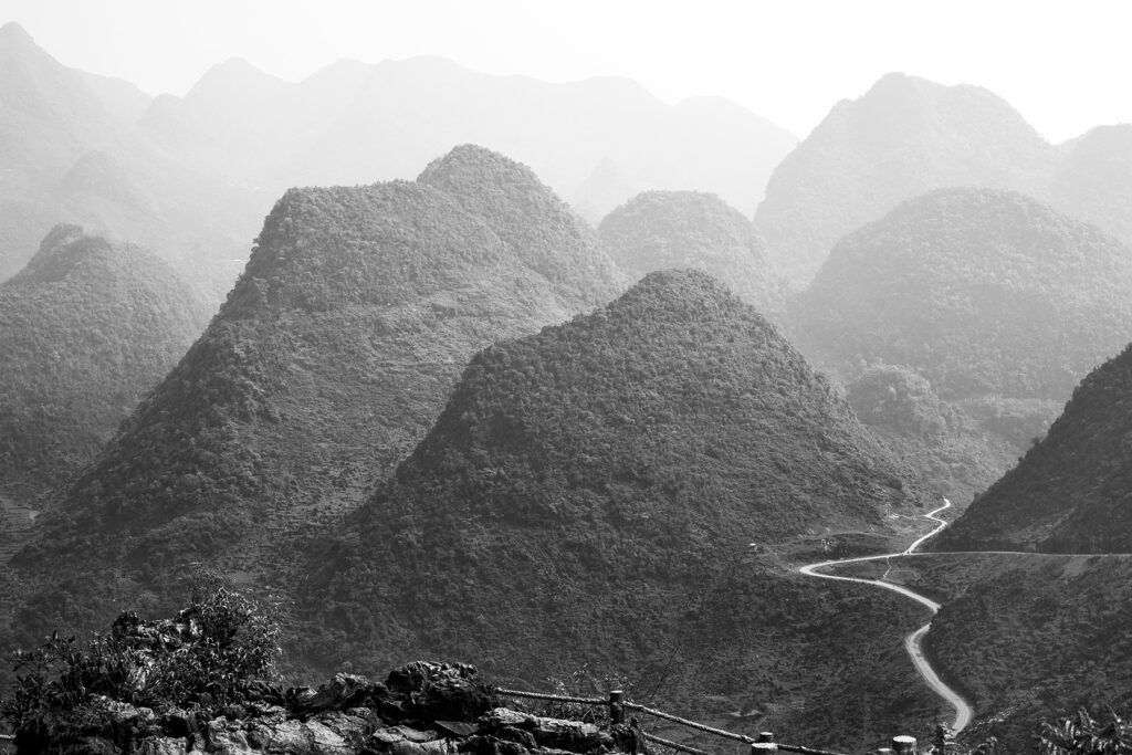 Black and white landscape travel photograph of mountains in Ha Giang