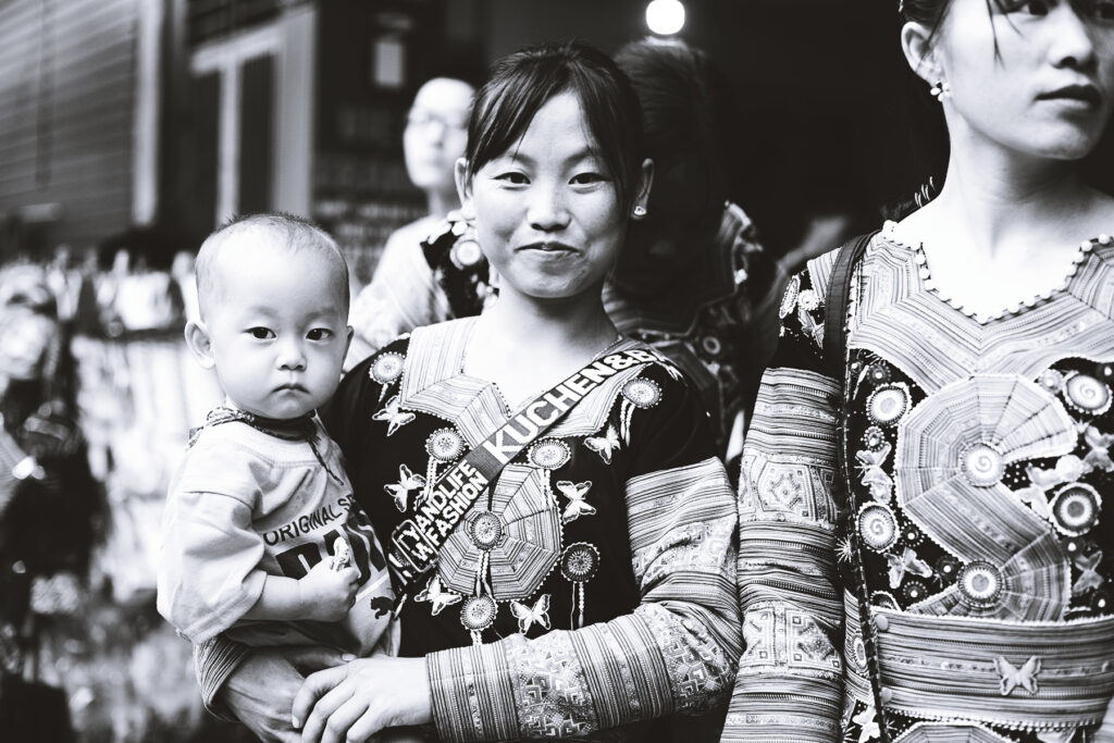 Black and white picture of traditionally dressed Hmong at the Moc Chau Love market Vietnam