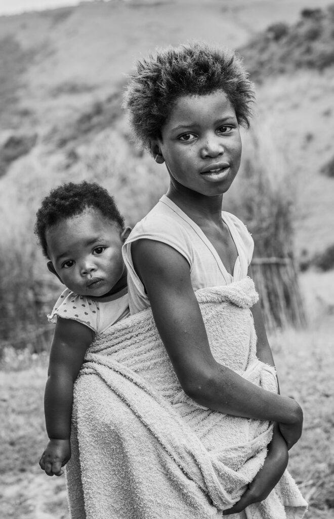 Black and white photo portrait of an African girl and baby