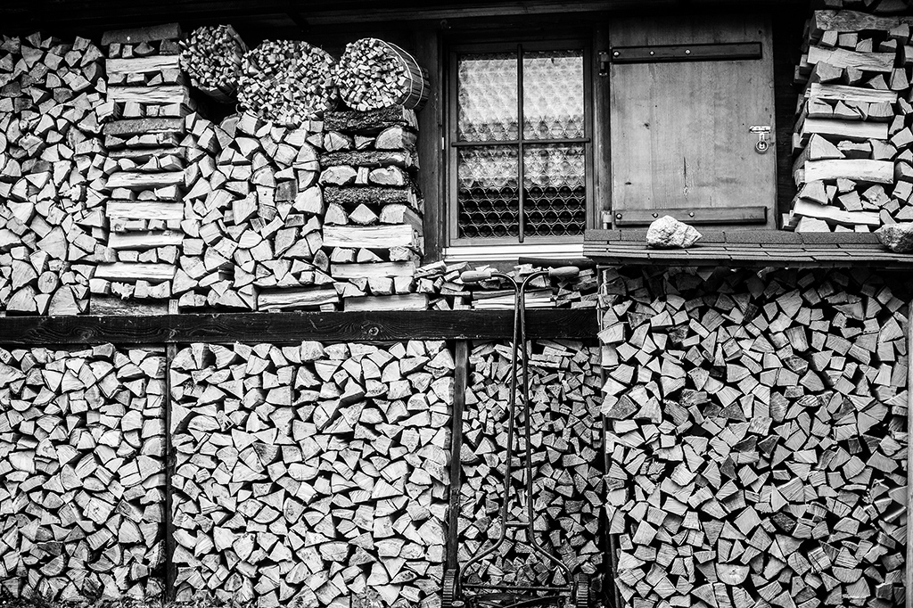 photo of Swiss wood stacked outside a cabin