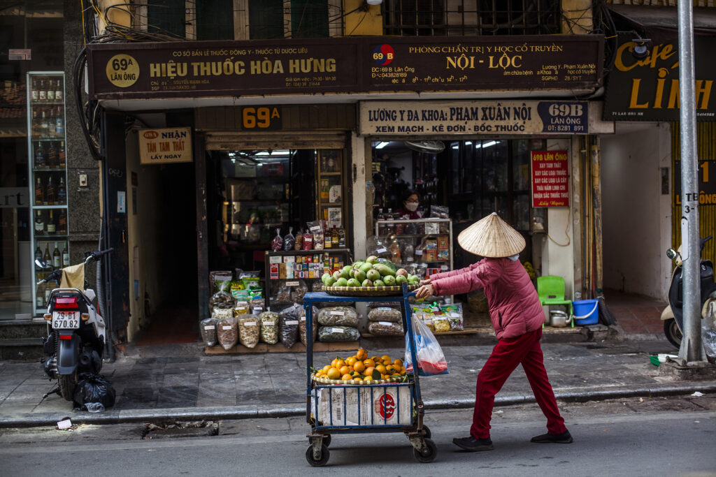 Picture of a fruit seller in the old Quarter Hanoi Vietnam street photography
