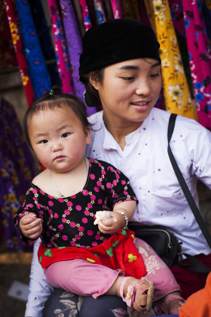 Colorful photo Portrait of a Hmong mother and baby at the market