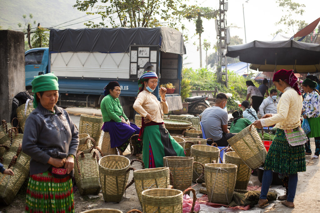 A wide shot of a collection of traditional Hmong woven baskets at a market