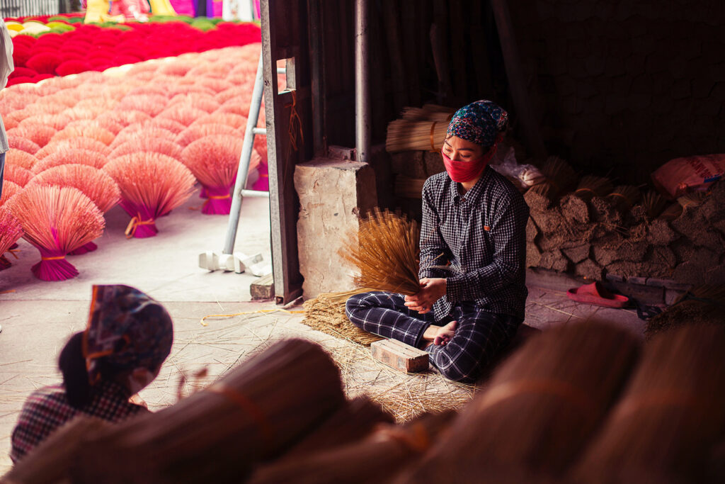 A Vietnamese woman sorting incense sticks at Quang Phu Cau Hanoi