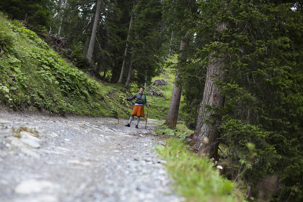 A self portrait picture of photographer Lavonne Bosman hiking in a Swiss Alps forest to Medergen village