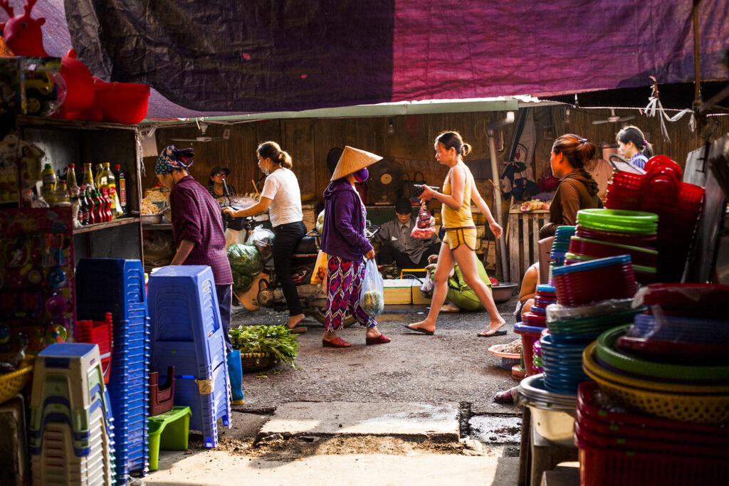 Vietnam street photography capture of people walking at early market