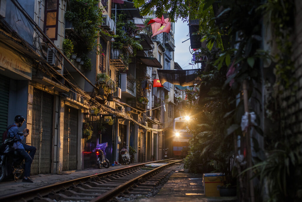 Art photo print taken at sunrise of a train arriving in a narrow allry