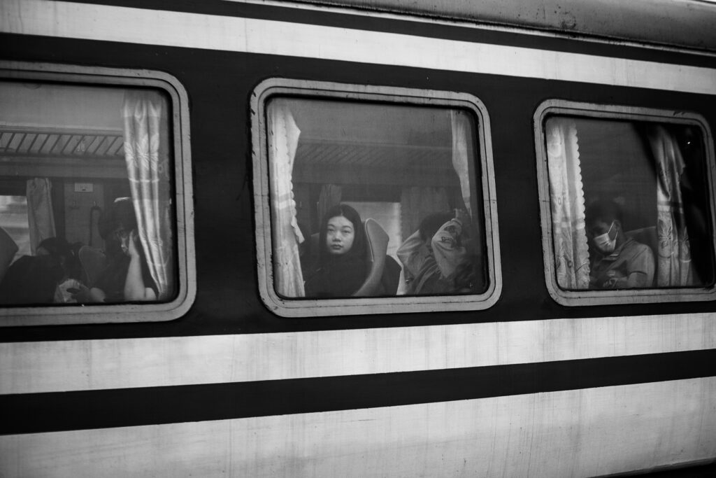 Contrasty Black and white street photography print of a girl on the train on Long Bien bridge Hanoi