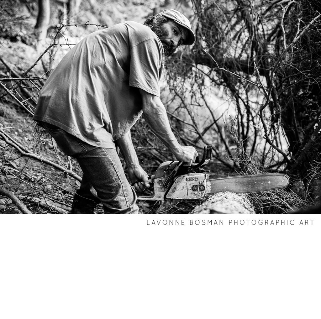 Wood cutter in the forest. Art portraits of Swiss Alps inhabitants in Medergen Alpen village, Switzerland. History of migration in the Swiss Alps