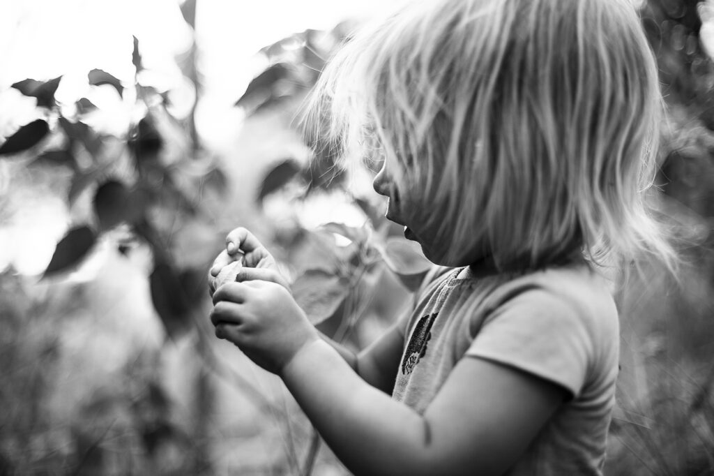 Little girl eating gooseberries